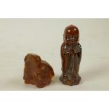 A Chinese carved horn figure of Buddha, together with an amber shard, 3" high