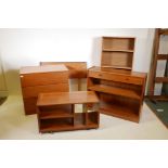 A 1970s teak chest of three drawers, a teak bookcase with single drawer, a teak trolley, an open