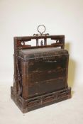 A C19th Chinese lacquered wood four section food box, with studded metal mounts and carrying case