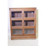 An early C20th teak bookcase with six glazed doors, 35" x 11" x 45"