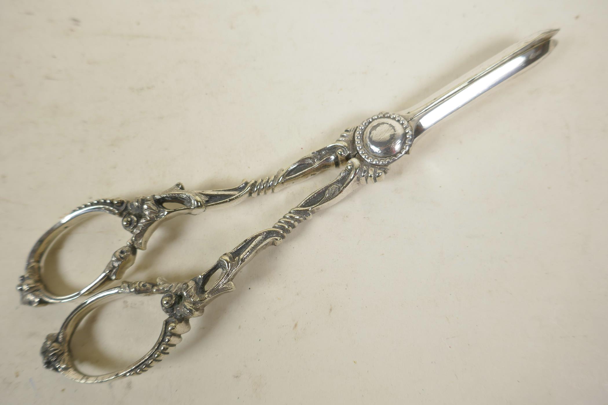 A pair of ornate silver plated grape scissors, 7" long