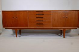 A Norwegian Gustav Bahus mid century teak sideboard with four doors and five drawers, probably by