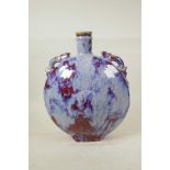A Chinese flambe glazed pottery moon flask with two dragon shaped handles, 13" high