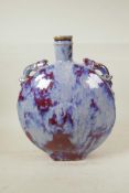 A Chinese flambe glazed pottery moon flask with two dragon shaped handles, 13" high