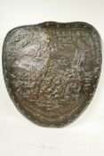 An embossed, shield shaped copper plaque decorated with a battle scene, 25" x 22"