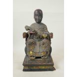 A Chinese carved and painted wood figure of an emperor seated on a throne holding a ruyi, with