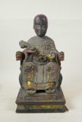 A Chinese carved and painted wood figure of an emperor seated on a throne holding a ruyi, with