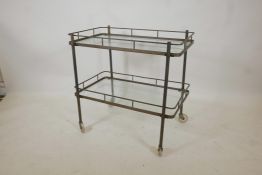 A brass and glass two tier hostess/drinks trolley in the Art Deco style, 28½" high, 29½" x 17½"