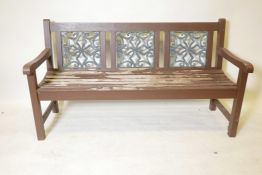 A painted garden bench with inset metal panels, 60" long, 33" high