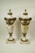 A pair of marble urns with gilt metal mounts and applied garlands, with cast goat mask handles, 18½"