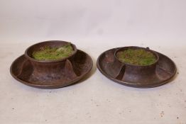 A pair of antique cast iron chicken feeders, 18" diameter