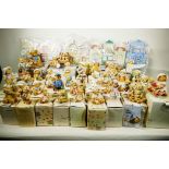 A collection of 37 'Cherished Teddies' figures with certificates and boxes plus village