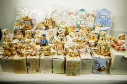 A collection of 37 'Cherished Teddies' figures with certificates and boxes plus village