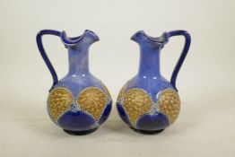 A pair of Royal Doulton blue and gilt bulbous jugs with pinched rims, 7" high