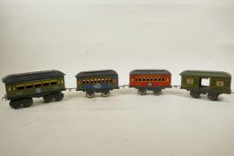 An 'American Flyer' tin plate rolling stock and three others, circa 1940, largest 6" long