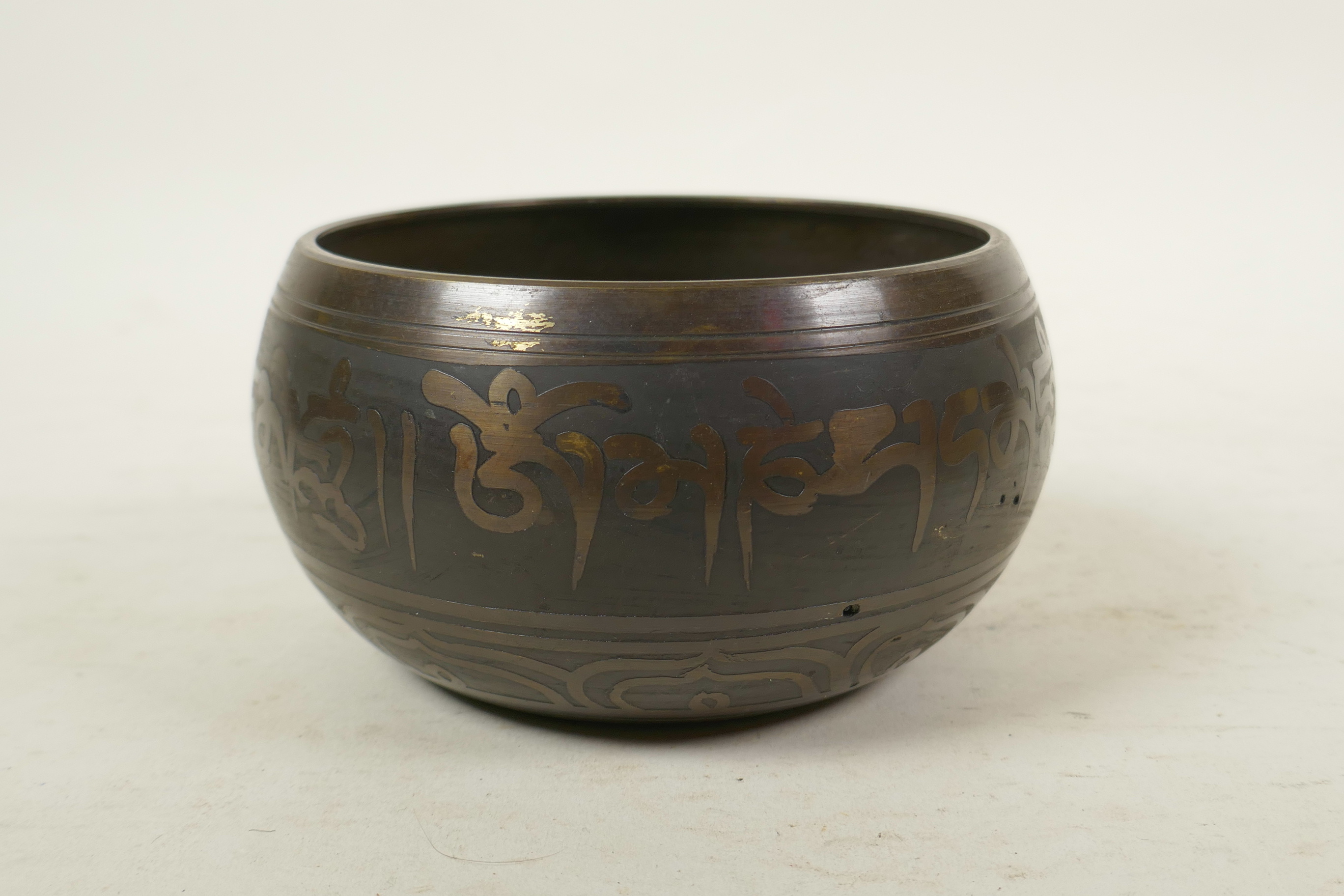 A Tibetan gilt bronze singing bowl, and another with character script decoration to exterior and - Image 3 of 7