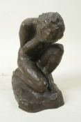 A stylised bronze figure of a kneeling nude girl with her knee in her hands, 7" high