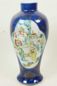 A Chinese blue lustre glazed baluster vase decorated with panels of figures in garden scenes, 10½"