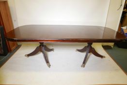 A Victorian style twin pedestal dining table with plank top, the pedestals with carved pineapple