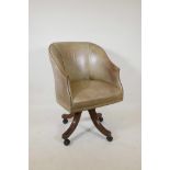 A good tub shaped swivel desk chair, with hide covers and brass stud decoration, raised on splay