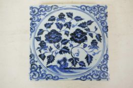 A Chinese blue and white porcelain temple tile, with floral decoration, 8" x 8"