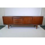 A Danish 1960s teak sideboard designed by Gunni Omann fo Axel Christiansen, with three sliding doors