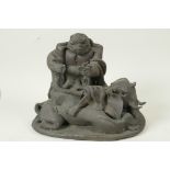 A stylised bronze figure of an ugly man seated on an elephant, 9" long, 7" high