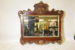 A good George III walnut and parcel gilt wall mirror with carved and applied decoration of scrolls