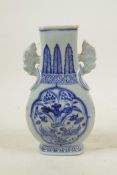 A Chinese blue and white pottery two handled vase of slender form, with decorative panels