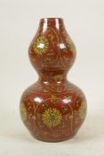 A Chinese red ground double gourd porcelain vase with ochre scrolling floral decoration, 6 character