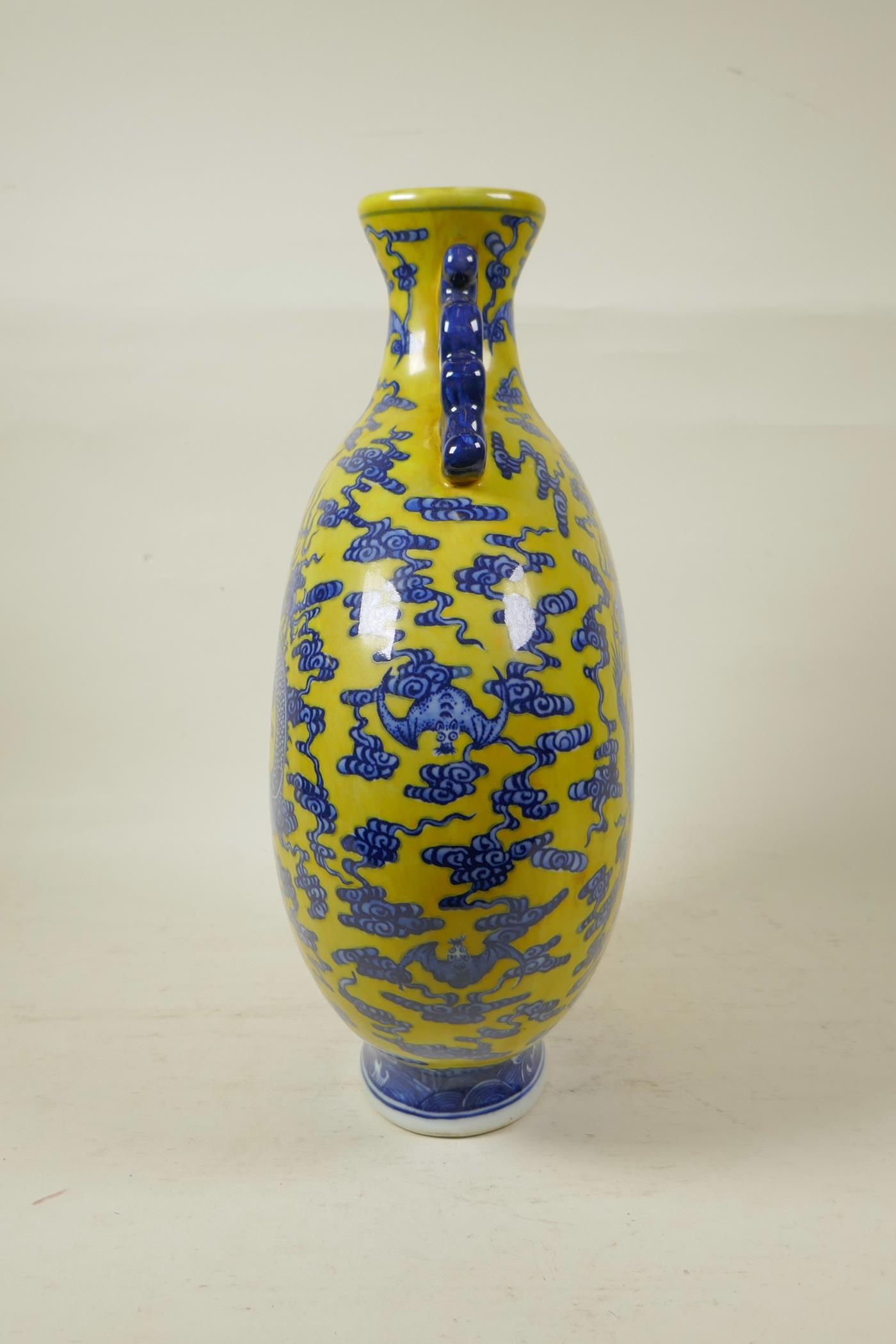A Chinese yellow ground porcelain two handled moon flask with blue and white dragon decoration, seal - Image 2 of 4