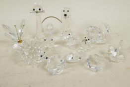 A collection of twelve Swarovski Crystal animals including a hedgehog, dog, cat, butterfly etc