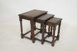 An early C20th nest of three oak tables with turned supports, 19" x 13", 19" high