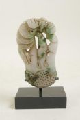 A Chinese mottled green and white jade ornament carved in the form of a buddha's hand citron,