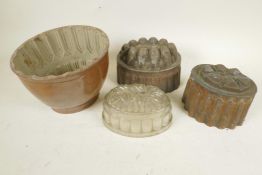 A stoneware jelly mould, 6" high, together with two copper moulds and a moulded glass example
