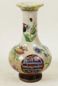 A Chinese crackle glazed pottery bottle vase decorated with butterflies, flowers and symbols, 7"