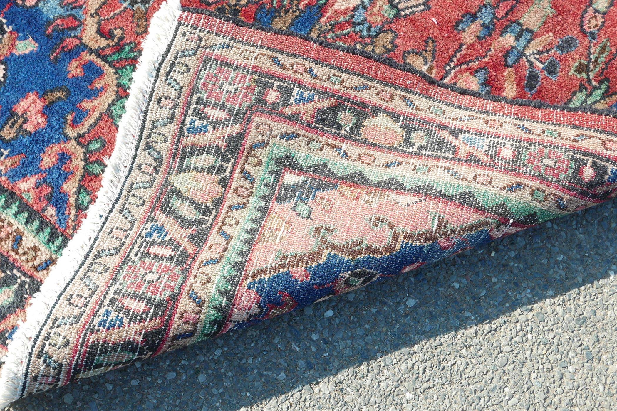 A full pile Sarouk runner with a traditional design on a red ground, 46" x 123" - Image 4 of 4