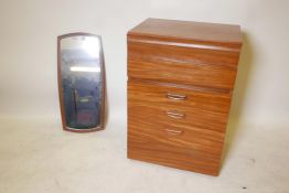 A 1970s teak chest of six drawers, labelled to the reverse, together with a mid century teak mirror,