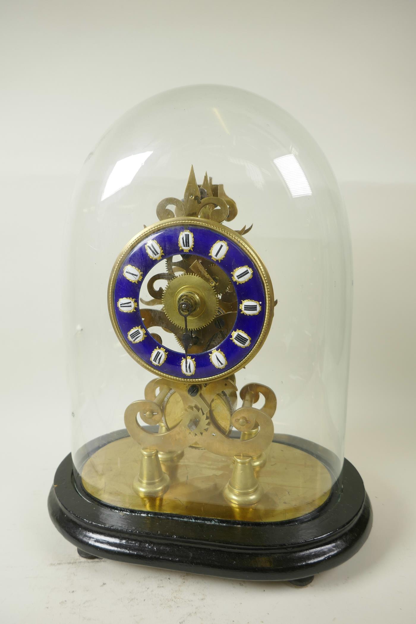 A replica brass skeleton clock with fusee movement and blue enamel chapter ring in Roman numerals,