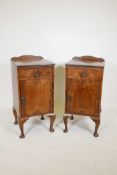 A pair of early C20th walnut pot cupboards with a single drawer and door, on cabriole feet, 15" x