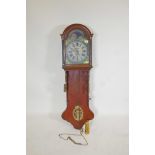 A C19th Dutch oak cased wall clock with weight driven movement striking on a gong, the painted
