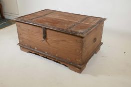 An Indian teak and brass mounted chest with decorative studs and half hinged fold over top, raised