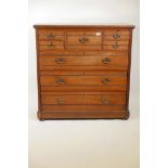 A 1920s walnut chest of drawers, five small over three long drawers, with reeded decoration, 41" x