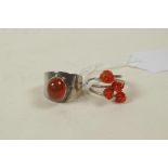 A retro 925 silver and carnelian set ring, and a silver crossover ring set with coral carved in