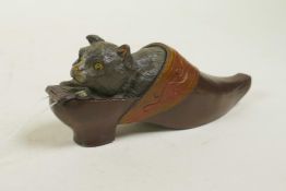 A cold painted bronze desk vesta case in the form of a cat in a clog, 4½" long