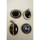A metal mounted agate eye bead brooch, together with two similar agate pendants and an agate bead,
