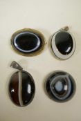 A metal mounted agate eye bead brooch, together with two similar agate pendants and an agate bead,