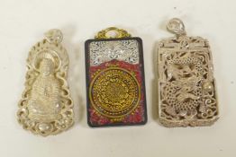 Two Chinese white metal pendants decorated with dragons and Buddha, and another composition and
