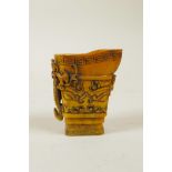 A Chinese carved horn libation cup with kylin decoration, 2½" high