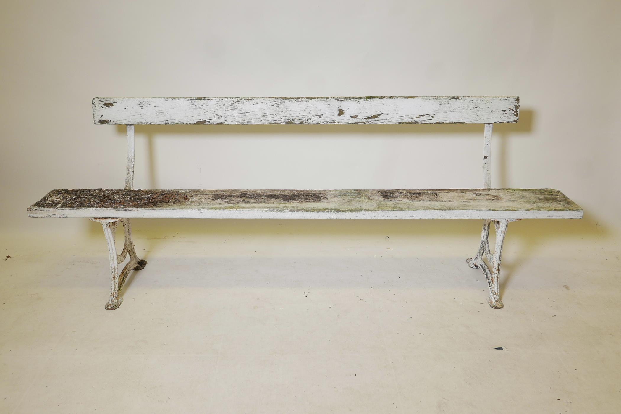 A vintage painted metal and wood low bench, 79" long